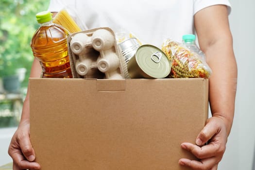 Foodstuffs in donation box for volunteer to help people.