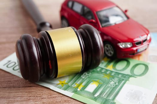 Bangkok, Thailand March 15, 2024 Car accident lawsuit and insurance, Judge hammer and money with car model.
