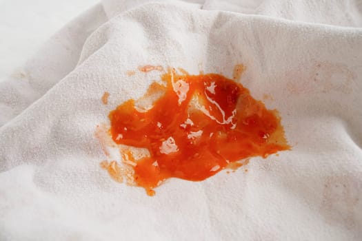 Dirty spicy sauce stain on cloth to wash with washing powder, cleaning housework.