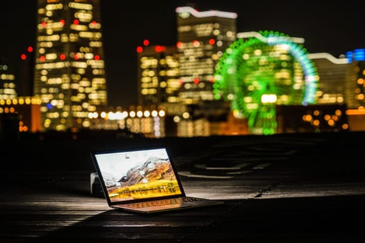 Yokohama night view and a laptop (Nomad worker of the image). Shooting Location: Yokohama-city kanagawa prefecture