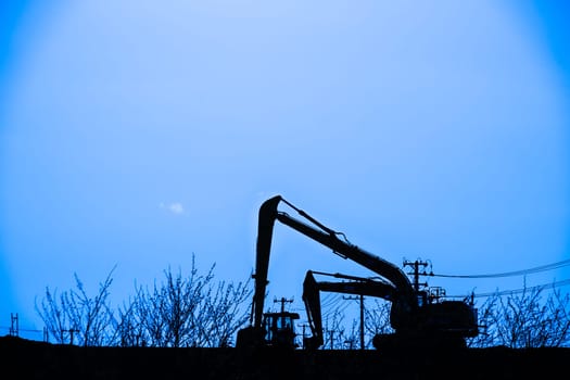 Power shovel and grassland of the silhouette. Shooting Location: Sendai, Miyagi Prefecture