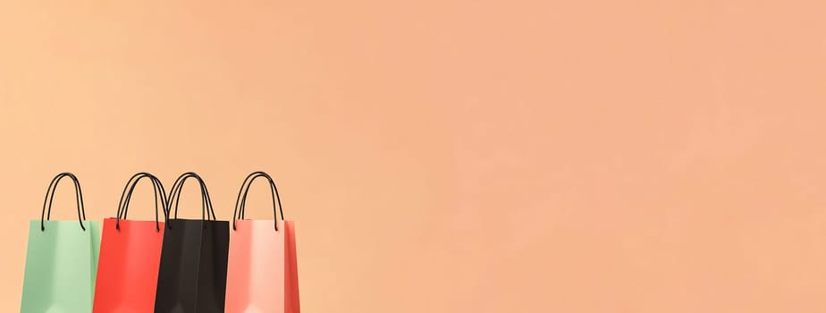 A collection of vibrant shopping bags in various colors lined up against a soft peach backdrop, showcasing a retail or gift shopping theme.
