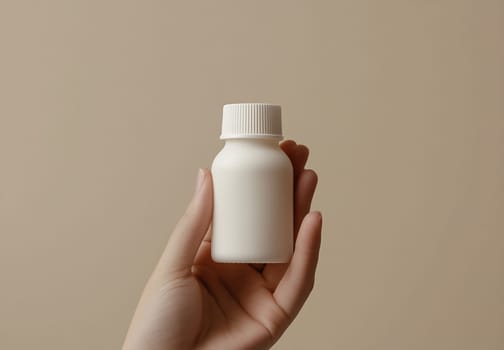 A person holds a small, plain white bottle with a ribbed cap against a neutral background, creating a minimalist aesthetic.