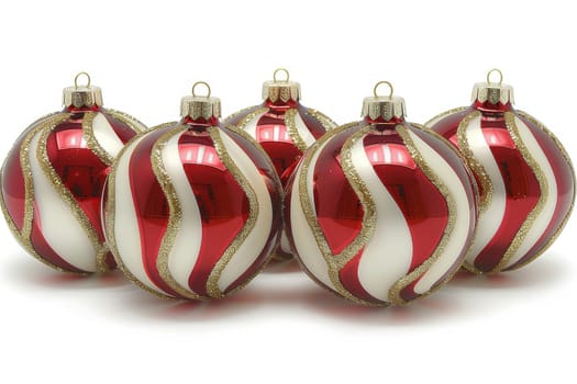 A collection of festive red and white Christmas ornaments featuring shiny and striped patterns. Perfect for holiday decoration, these elegant ornaments add charm to the seasonal festivities.