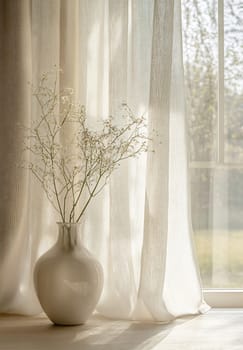 A simple vase filled with delicate flowers sits beside a sunlit window, casting soft shadows on a light wooden surface.