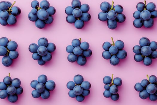 Blue grapes are neatly arranged in clusters on a soft pink background, creating a visually appealing display of fruit.