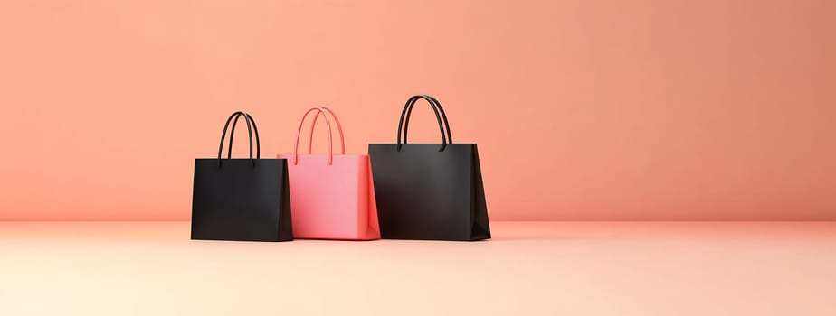 Three shopping bags in pink and black arranged against a soft peach background, showcasing modern design and retail themes.
