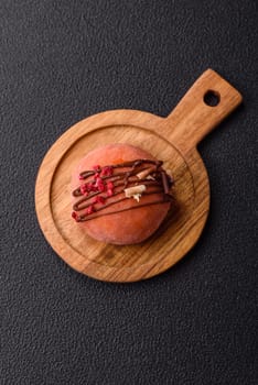 Delicious colorful asian mochi sweets with rice dough shell and fruit filling on dark concrete background
