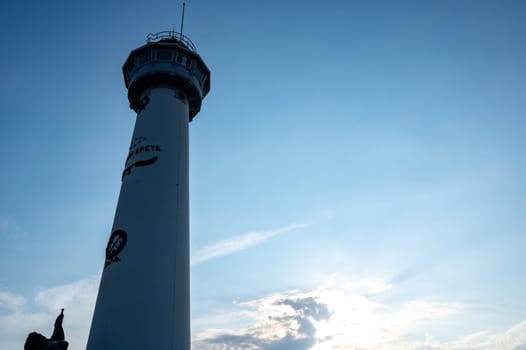 The approx. 28 m high white lighthouse J.C.J. van Speijk in Egmond aan Zee, North Holland, Netherlands at sunset