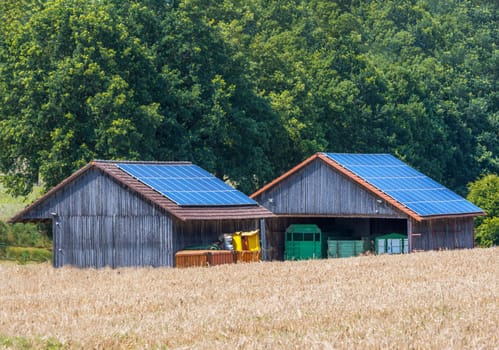 Green energy with solar collectors on the roof of agricultural buildings