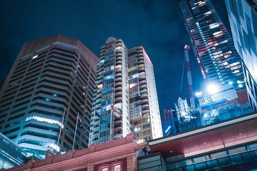 Night view of skyscrapers and cranes under construction. Shooting Location: sydney, australia