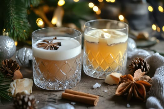 Two elegant glasses filled with festive cocktails sit among holiday decorations and pinecones evoking a cozy Christmas atmosphere.