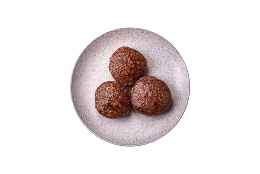 Beef burger patties with salt, spices and herbs grilled on a white background