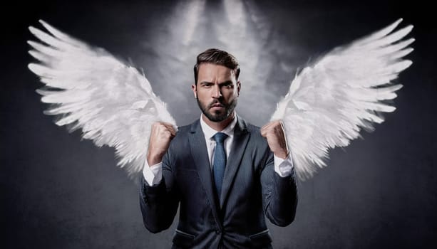 Business person in a suit with large white angel wings extending from his back. Businessman standing with fists raised showing his power as celebrating success