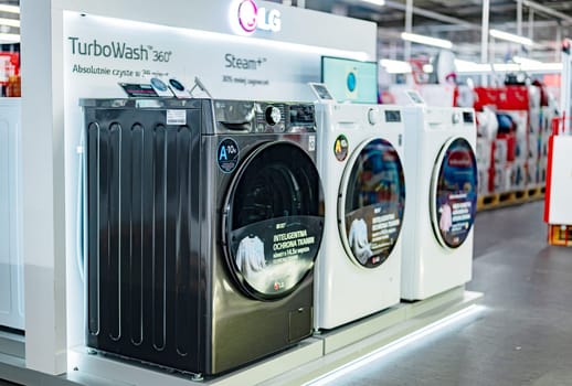 POZNAN, POL - DEC 5, 2024: Front-loader washing machines by LG put up for sale in a household goods store