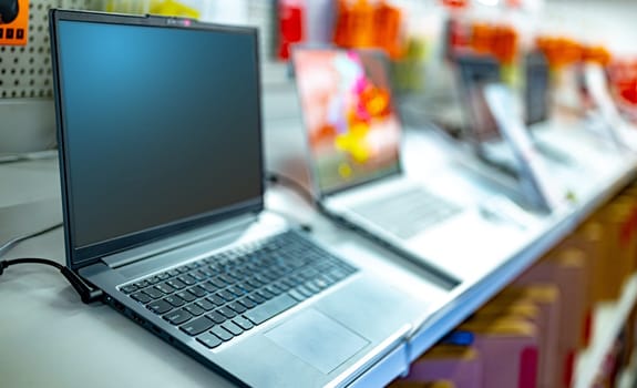 Laptop computers put up for sale in a store.