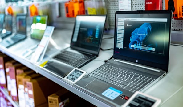 POZNAN, POL - DEC 5, 2024: Laptop computers put up for sale in a store.