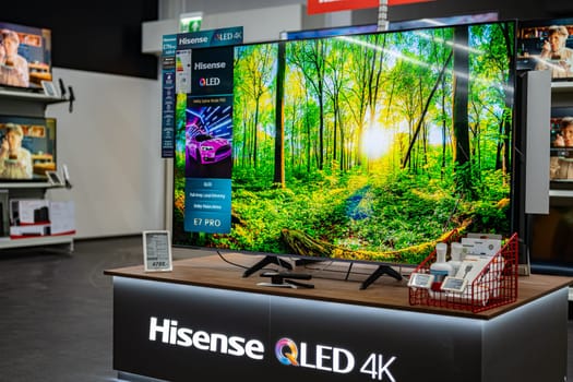 POZNAN, POL - DEC 5, 2024: Modern flat-screen TV sets put up for sale in an electronics store