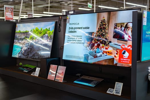 POZNAN, POL - DEC 5, 2024: Modern flat-screen TV sets put up for sale in an electronics store