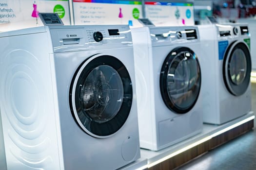 POZNAN, POL - DEC 5, 2024: Front-loader washing machines by Bosh put up for sale in a household goods store