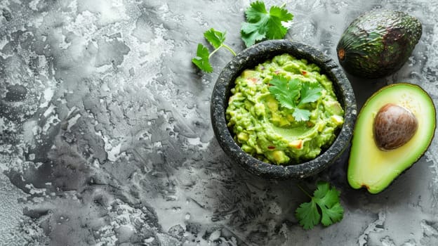 A top-down view of guacamole in a stone mortar, flanked by halved avocados and fresh cilantro. The composition highlights the ingredients' natural textures and colors