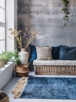 A rustic corner featuring a wicker sofa with blue pillows against a textured grey wall