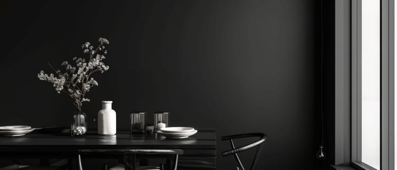 A modern black dining table is accentuated with botanical elements and simplistic tableware under subtle lighting, offering a blend of sophistication and nature