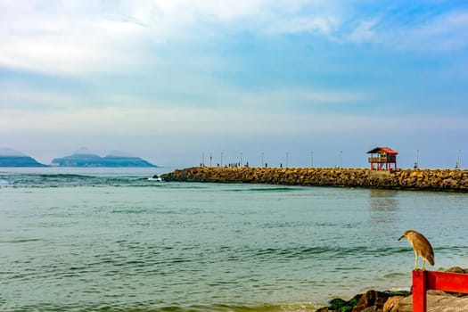 Breakwater and canal connecting the Barra da Tijuca lagoon to the sea with the islands in the background