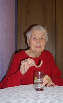 flexible nylon denture on senior female hands. Removable dentures flexible, devoid of nylon, hypoallergenic exempt from monomer