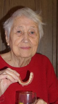 flexible nylon denture on senior female hands. Removable dentures flexible, devoid of nylon, hypoallergenic exempt from monomer