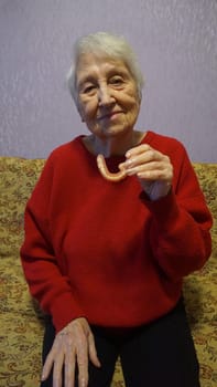 flexible nylon denture on senior female hands. Removable dentures flexible, devoid of nylon, hypoallergenic exempt from monomer