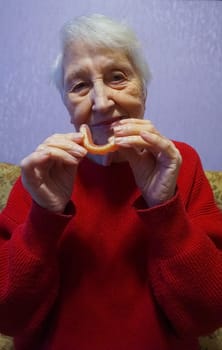 flexible nylon denture on senior female hands. Removable dentures flexible, devoid of nylon, hypoallergenic exempt from monomer