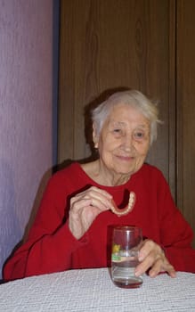 flexible nylon denture on senior female hands. Removable dentures flexible, devoid of nylon, hypoallergenic exempt from monomer