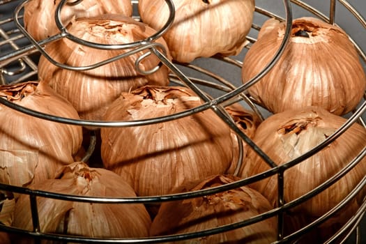 black fermented garlic in a grid basket
