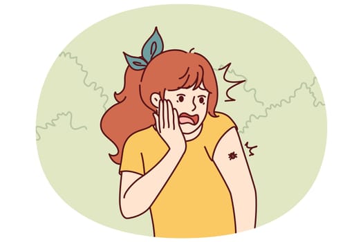 Frightened teenage girl with tick crawling on arm screams for fear contracting infection from insect. Little schoolgirl in park screams sees beetle on shoulder suffering from arachnophobia