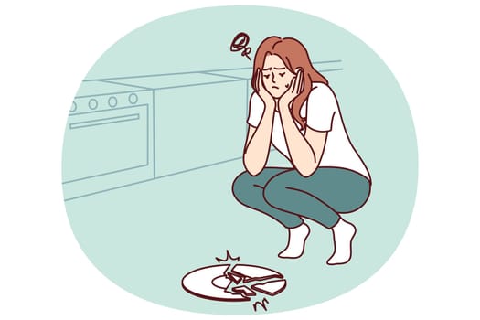 Sad woman broke plate in kitchen and is sad because of favorite saucer given by friends. Frustrated housewife girl dropped ceramic plate while cooking dinner and needs to buy new dishes