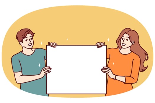 Happy couple with blank poster with copy space for your promotional offer or company logo. Man and woman show blank poster for application of information with announcement of favorable discounts