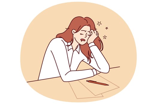 Tired girl student sleeps sitting at table with papers while filling out test or preparing for exams. Concept of burnout and overload during training before college or university entrance exams