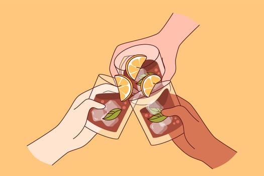 Alcohol drink in glasses in hands of people drinking whiskey with pieces of lime and ice cubes. Alcohol party for bar visitors enjoying cold strong brandy or cognac from restaurant wine list