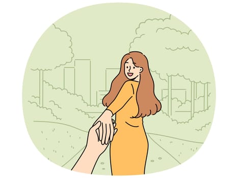 Woman says follow me and takes boyfriend to park for friendly or romantic date in summer nature. Happy girl holding friend hand and turning around, posing for photo in follow me style