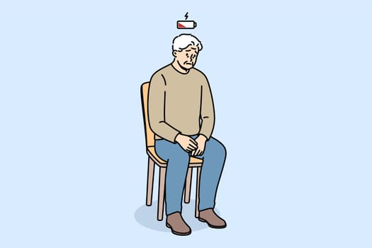 Depletion of vitality is felt by elderly man sitting on chair, with empty battery above head. Depletion of vitality in pensioner who needs support from friends and relatives to avoid depression