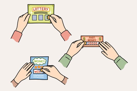 Lottery tickets in hands of gambling people who erase protective layer to find out winning amount. Players play lottery in hopes of getting lucky and winning jackpot or big cash prize.