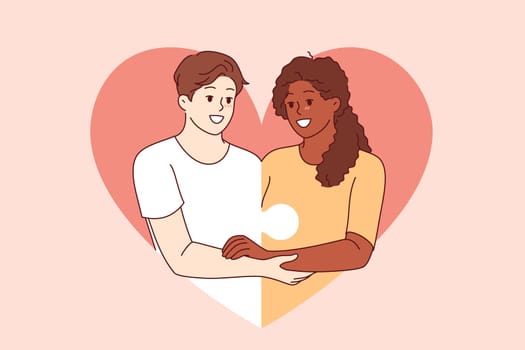 Love between diverse couple and with man and woman holding hands and consisting of puzzle pieces. Multiracial love or romantic relationships through mutual understanding or equality