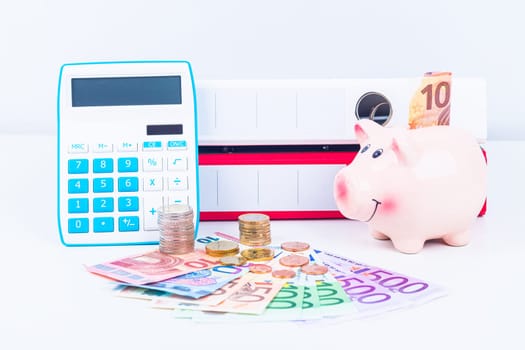 financial background with piggy bank, calculator, folders and money in euro currency