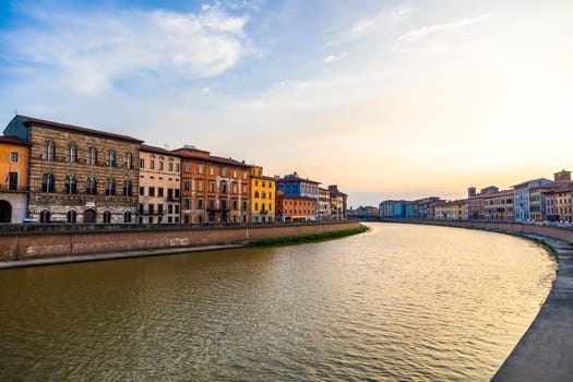 Pisa, Italy - 30 April 2024. The view of Arno river at sunset. Skyline cityscape.