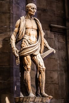MILAN, ITALY - JULY 28, 2024: statue of Saint Bartholomew flayed - San Bartolomeo Scorticato - in Milan Cathedral, second half of 16th century.