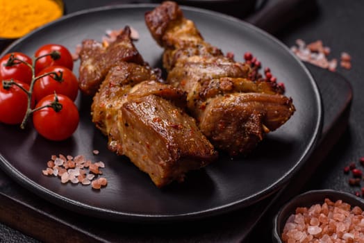 Delicious grilled chicken, turkey or pork skewers with salt, spices and herbs on a fire on a dark concrete background