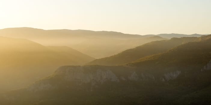 Sunset in the mountains of Crimea, Sunset landscape with rays of sun and mountains.
