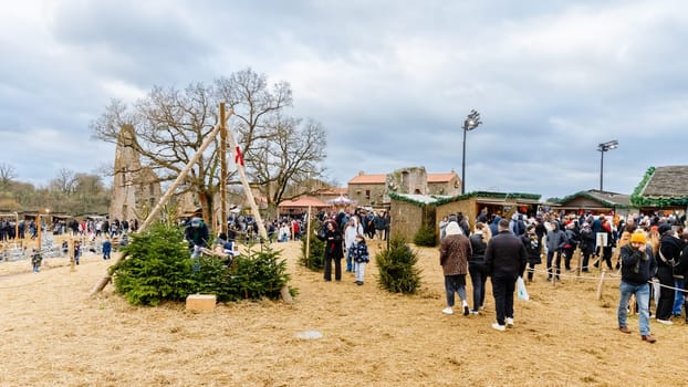 Tiffauges, Vendee, France - December 8, 2024: Street atmosphere and architecture at the Christmas Market at Tiffauges Castle on a gray winter day