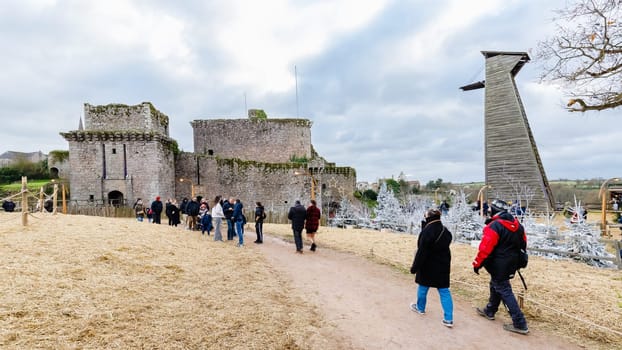Tiffauges, Vendee, France - December 8, 2024: Street atmosphere and architecture at the Christmas Market at Tiffauges Castle on a gray winter day